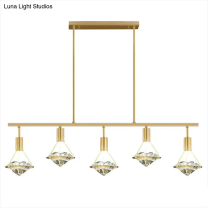 Modern gold finish light fixture with five crystal diamond-shaped shades for kitchen island lighting