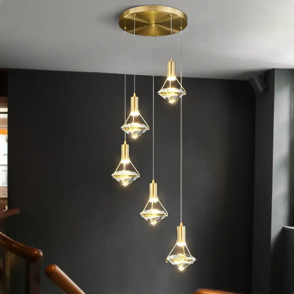 Gold finish pendant light fixture with crystal glass shades hanging from a circular ceiling mount for kitchen island