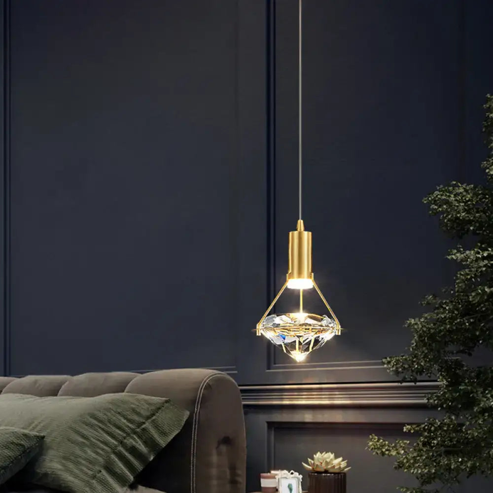 Modern gold finish crystal pendant light fixture with faceted centerpiece and metal frame for kitchen island lighting