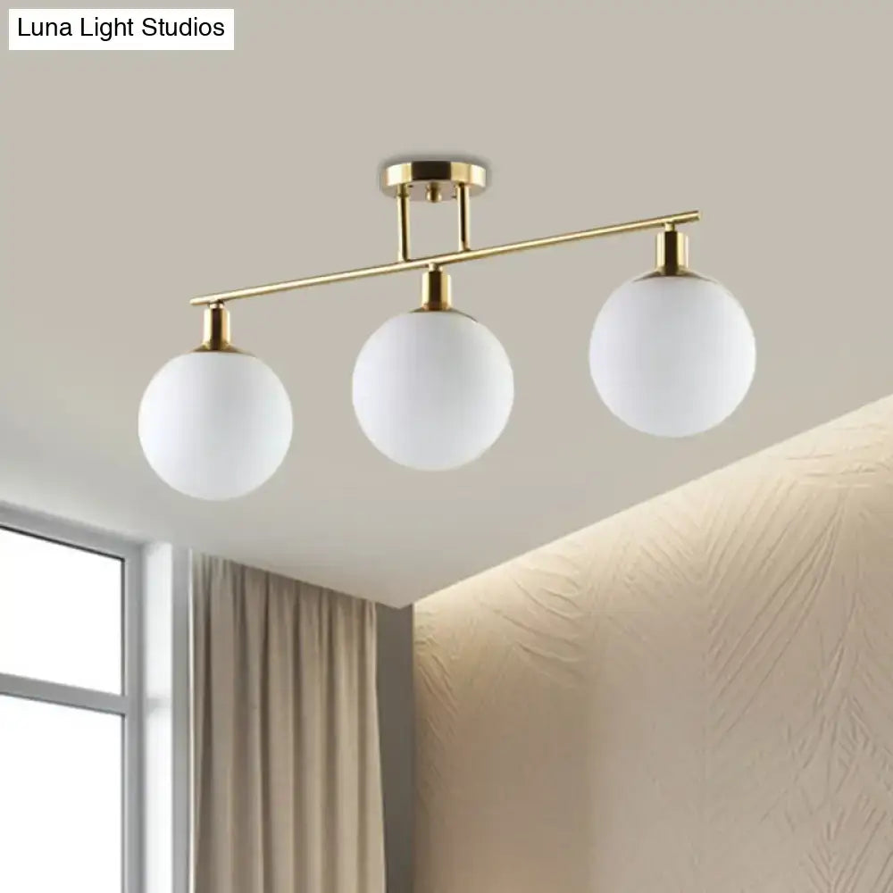 Modern gold finish linear chandelier with three frosted milk glass orb shades from decorbites pendant light series