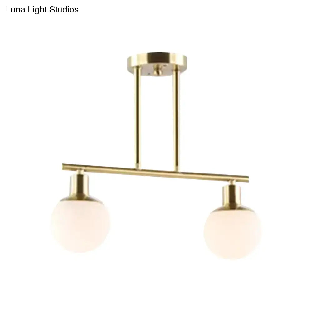 DecorBites modern linear chandelier with two milk glass globes and brass gold finish ceiling pendant light