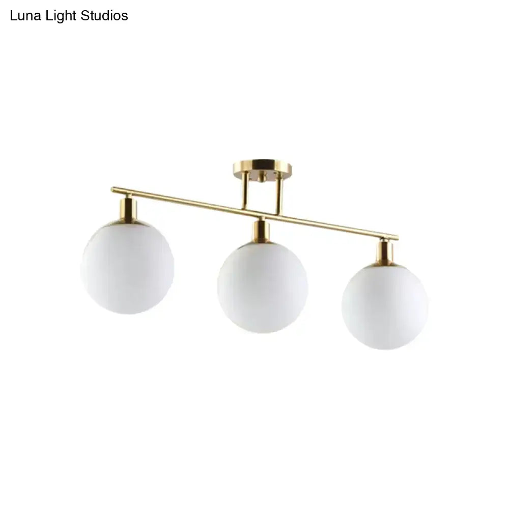 DecorBites™ modern linear chandelier with three milk glass orb shades in gold finish for elegant lighting