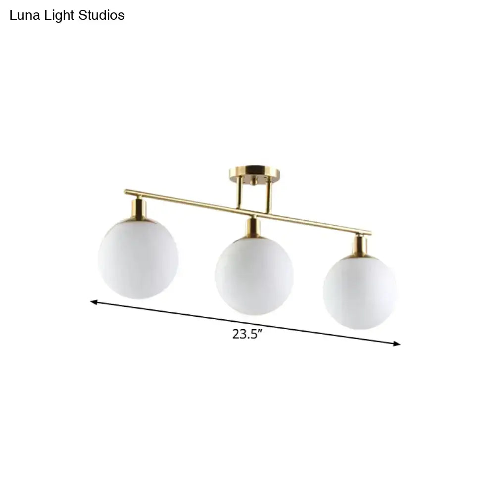 Decorbites modern linear chandelier with three milk glass orb shades and gold finish polished brass frame
