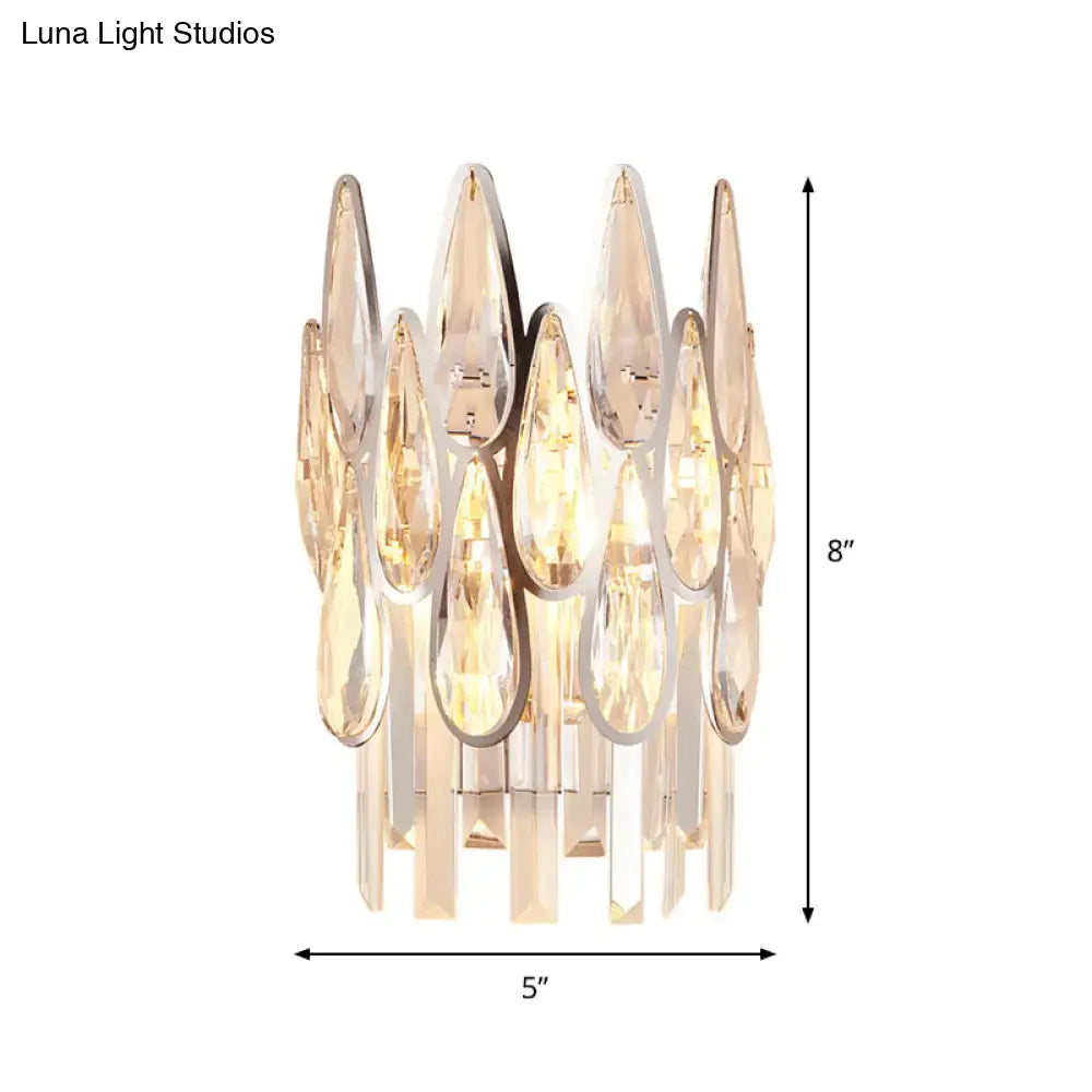 Modern gold finish wall lamp with teardrop crystal glass pieces and sleek chrome frame for bedroom sconce lighting
