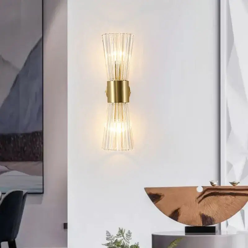 Modern gold wall sconce with fluted crystal glass shades featuring minimalist design for living room lighting decorbites crystal wall