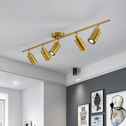 Gold-colored decorbites adjustable led ceiling spotlight with four adjustable spotlights on a modern bar fixture