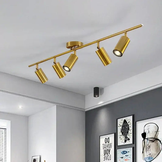Gold-colored decorbites adjustable led ceiling spotlight with four adjustable spotlights on a modern bar fixture