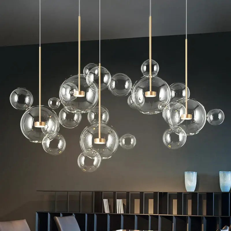 Modern gold frosted glass ball pendant light with glass bubbles and metal rods for dining room illumination