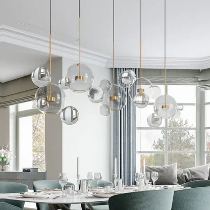 Modern gold frosted glass ball pendant light with frosted glass and metal accents for dining room illumination