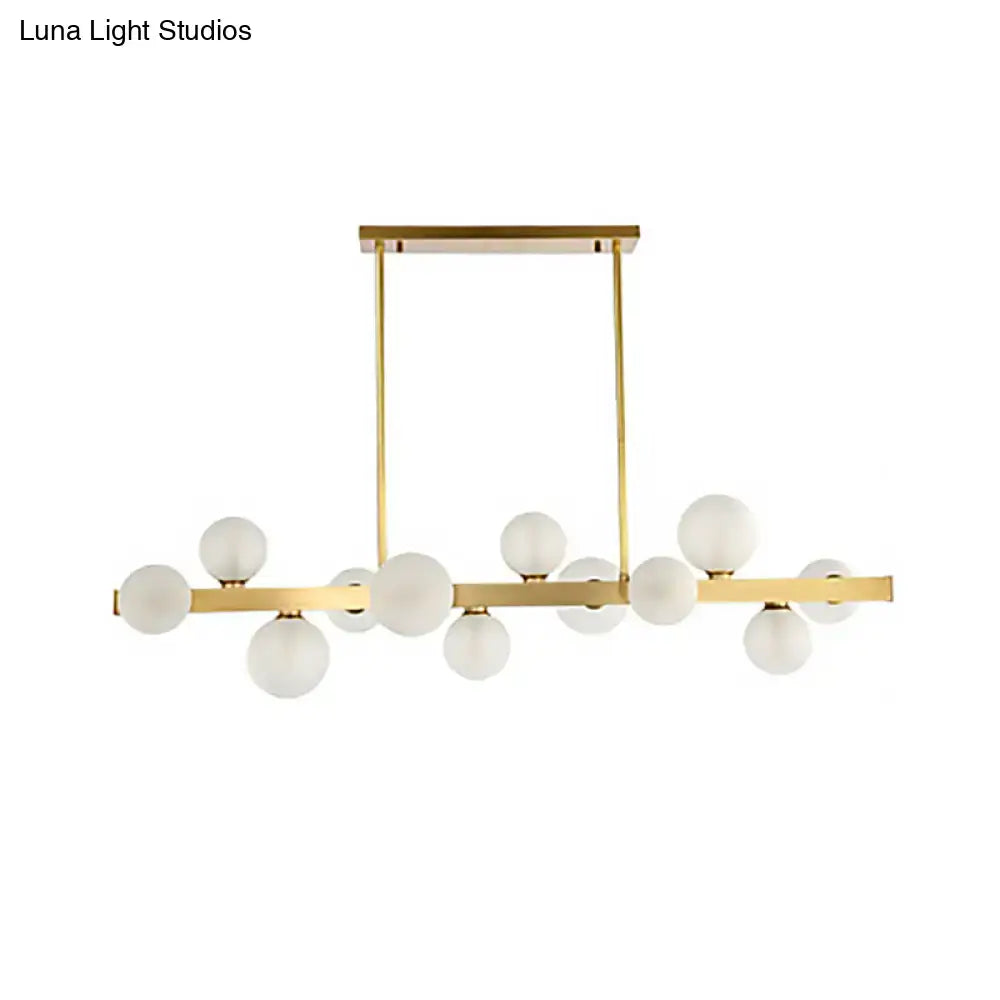 Modern gold frosted glass globe pendant light with chain cord length features linear bulbs for dining room island lighting
