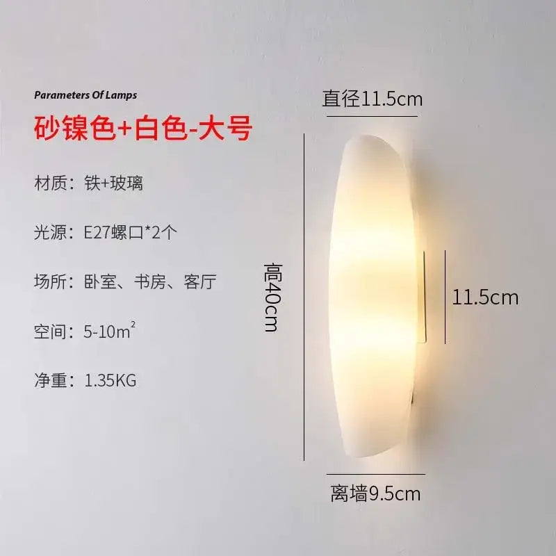 Modern gold led wall lamp with brushed metallic finish and frosted glass diffuser emitting warm bedroom light