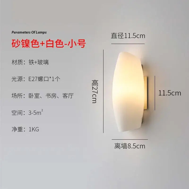 A modern gold led wall lamp with frosted white glass and satin brass backplate for bedroom lighting