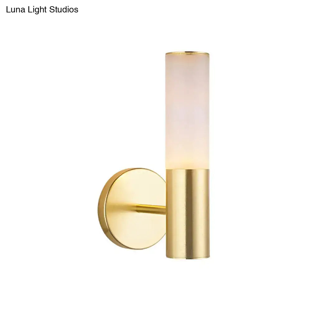 Modern gold frosted glass wall lamp featuring a gold-toned cylindrical sconce with frosted glass diffuser for bedroom use