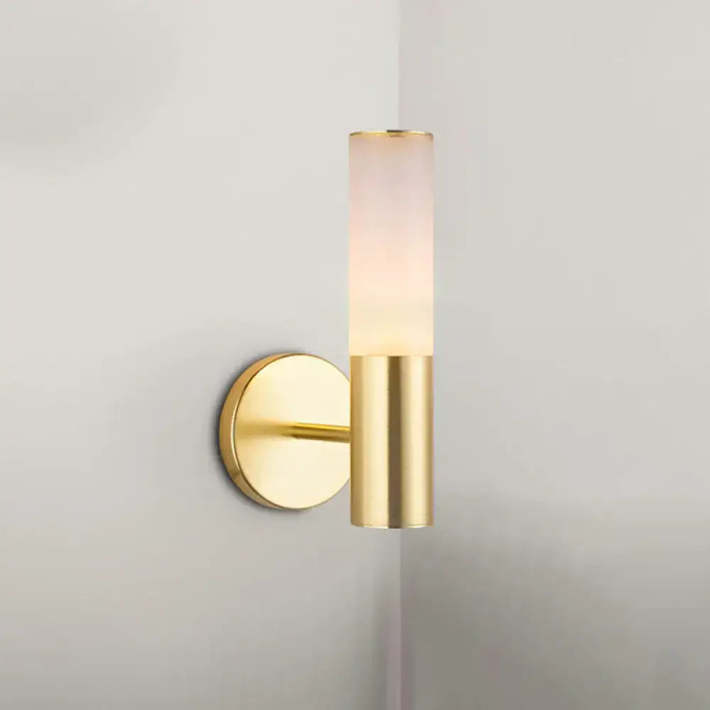 Modern gold frosted glass wall lamp featuring a gold-toned cylindrical sconce with frosted glass diffuser for bedrooms