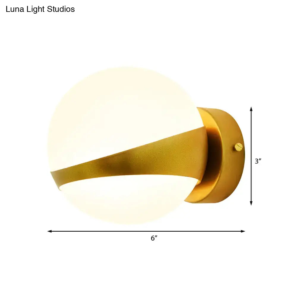 Modern gold frosted glass wall sconce with direct wired spherical shade and sleek metallic accent for bedroom lighting