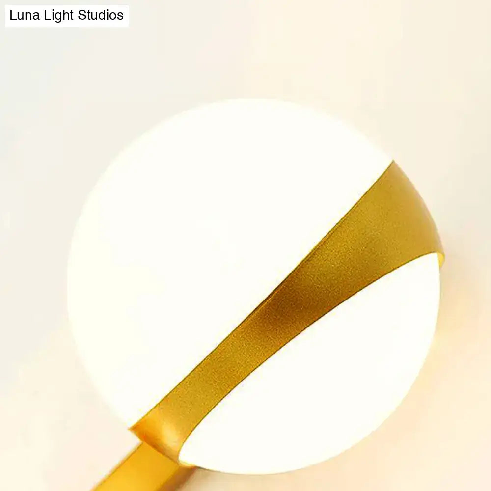 Modern gold frosted glass wall sconce with matte white diffuser and satin gold band for bedroom direct wired lighting