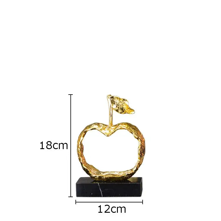 Modern gold fruit shaped metal crafts apple sculpture with textured surface and leaf on black marble decorbites base