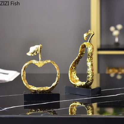 Modern gold fruit shaped metal crafts with textured metallic surfaces on black bases for living room decorbites decor