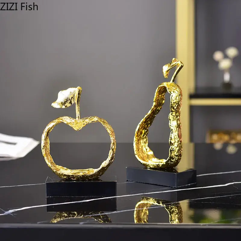 Modern gold fruit shaped metal crafts with textured metallic surfaces on black bases for living room decorbites decor