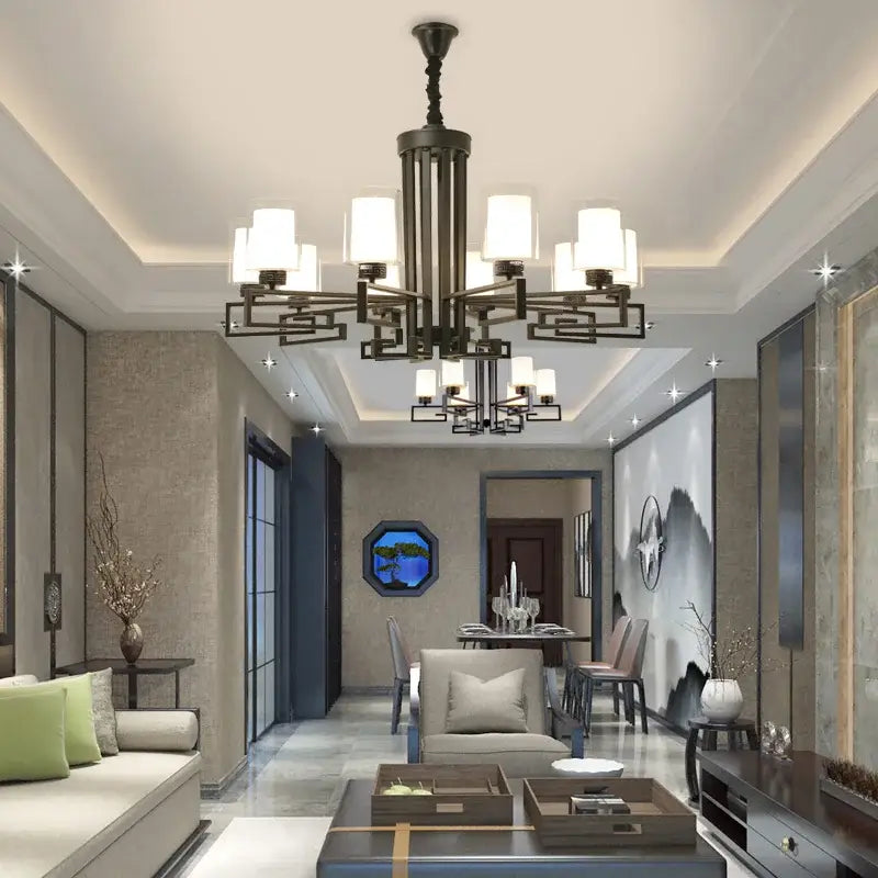 Black metal living room chandelier with multiple white cylindrical shades for luxury living room lighting