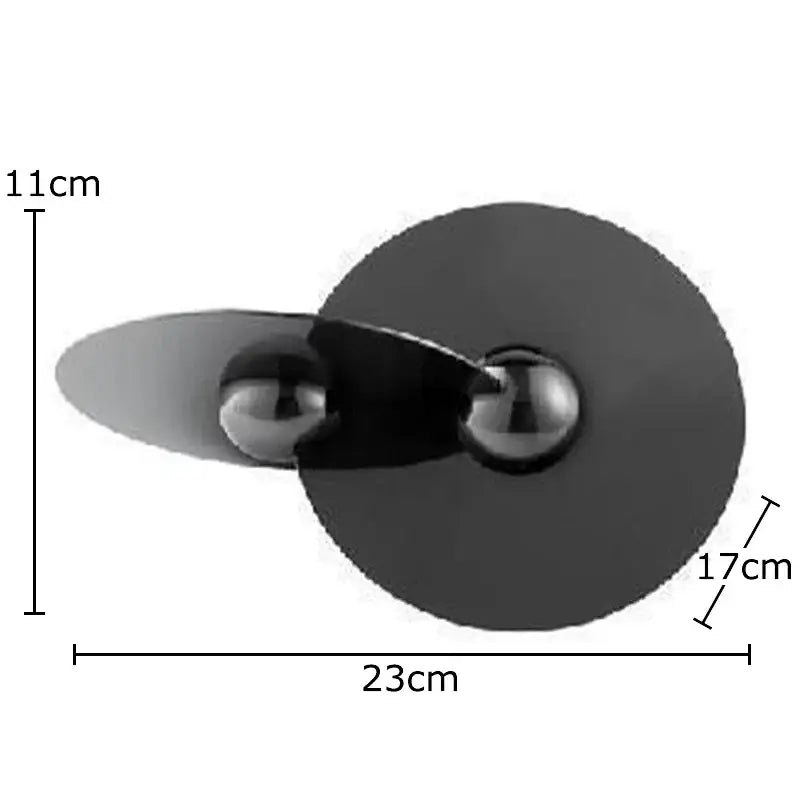 Black metallic table lamp with sleek modern design and two spherical bulbs complementing geometric circle sculpture decor