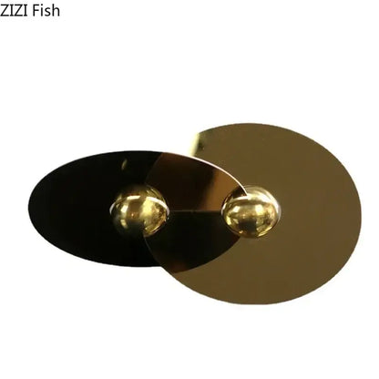 Modern gold and black metallic geometric circle sculpture pendant with spherical accents for living room decor