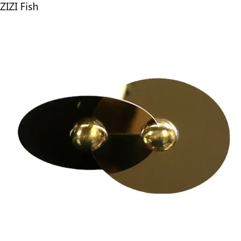 Modern gold and black metallic geometric circle sculpture pendant with spherical accents for living room decor