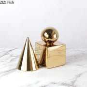 Modern gold metallic geometric cube round statue decor featuring cone and cube shapes for living room display