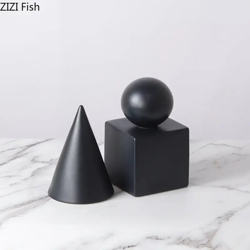 Modern black matte geometric decor set featuring a cube round statue with a cone and sphere for living room display