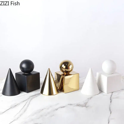 Set of modern gold geometric cube round statue decor featuring matte black, glossy gold, and white ceramic shapes with spherical tops