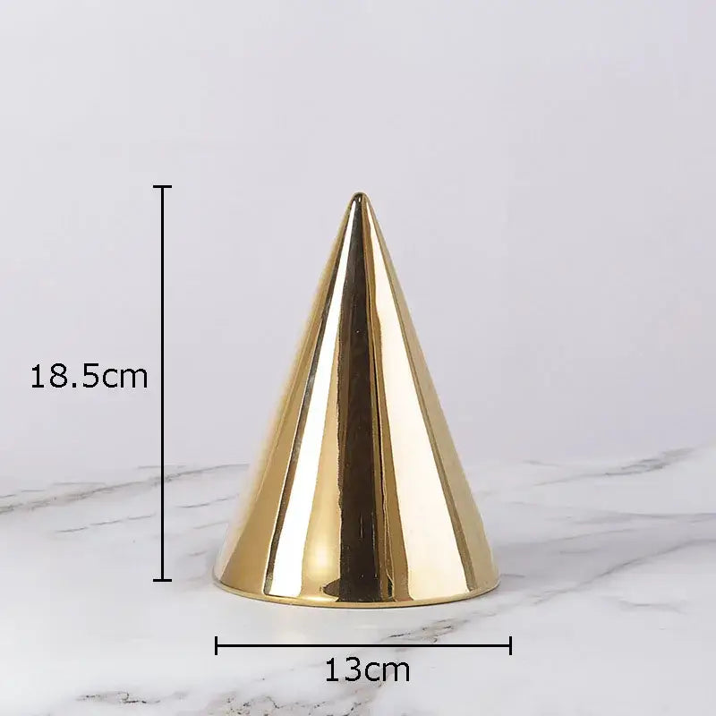A sleek glossy gold cone-shaped modern cube round statue with smooth reflective surface for living room decor