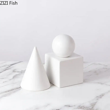 White ceramic modern gold geometric cube round statue decor set featuring cone cube and sphere for living room
