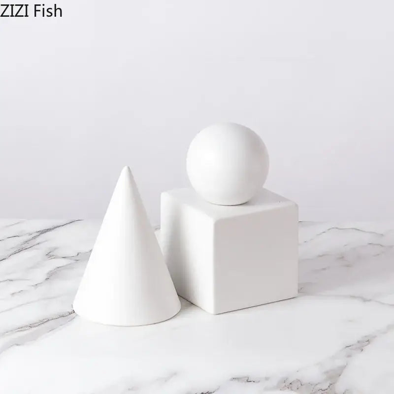 White ceramic modern gold geometric cube round statue decor set featuring cone cube and sphere for living room