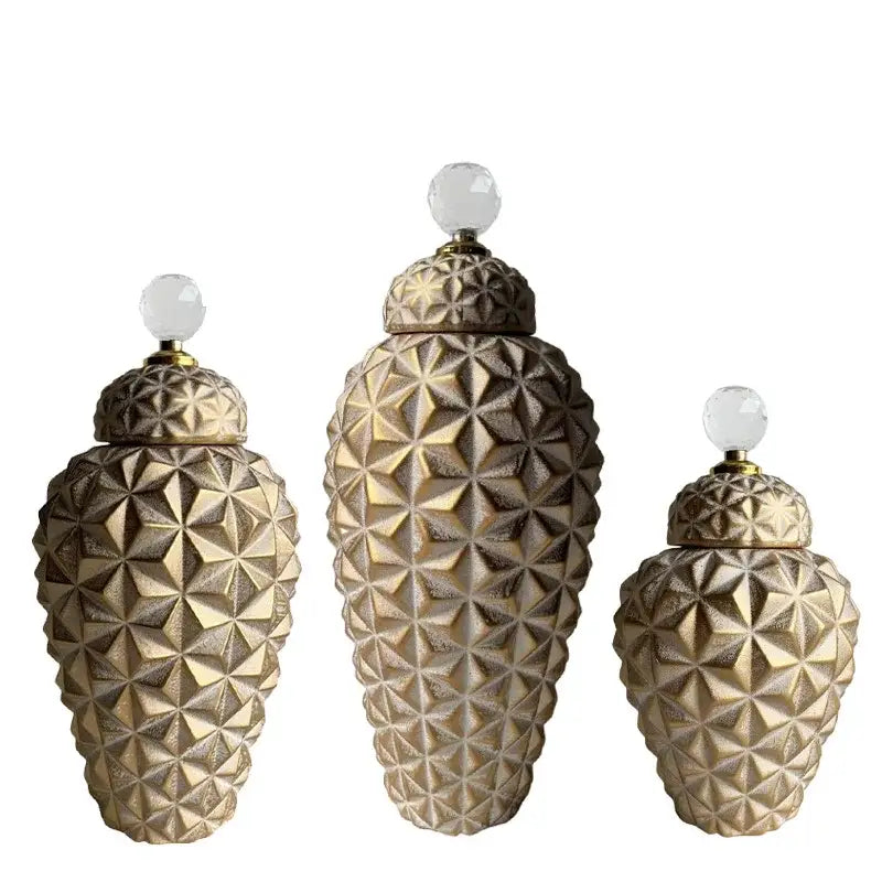 Set of three gold-toned geometric diamond ceramic canisters with faceted patterns and crystal knobs for modern decorbites decor
