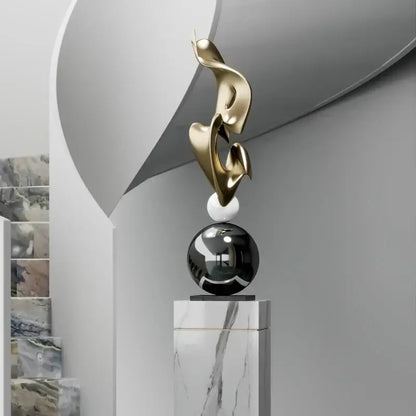 Modern gold geometric electroplating art sculpture with flowing forms on marble sphere and black orb for living room decor