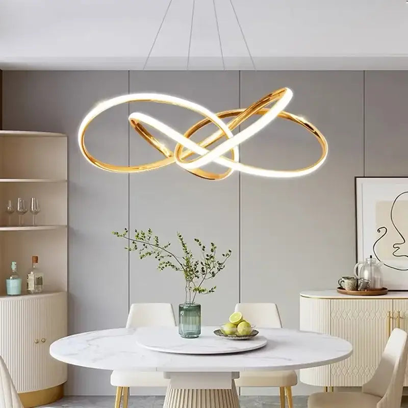 Modern gold geometric led ceiling pendant light featuring a gold-toned infinity-loop design with glowing white light decorbites geometric led