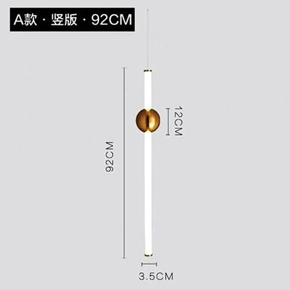 A sleek modern pendant light with a long white cylindrical body and polished gold geometric line frame accent