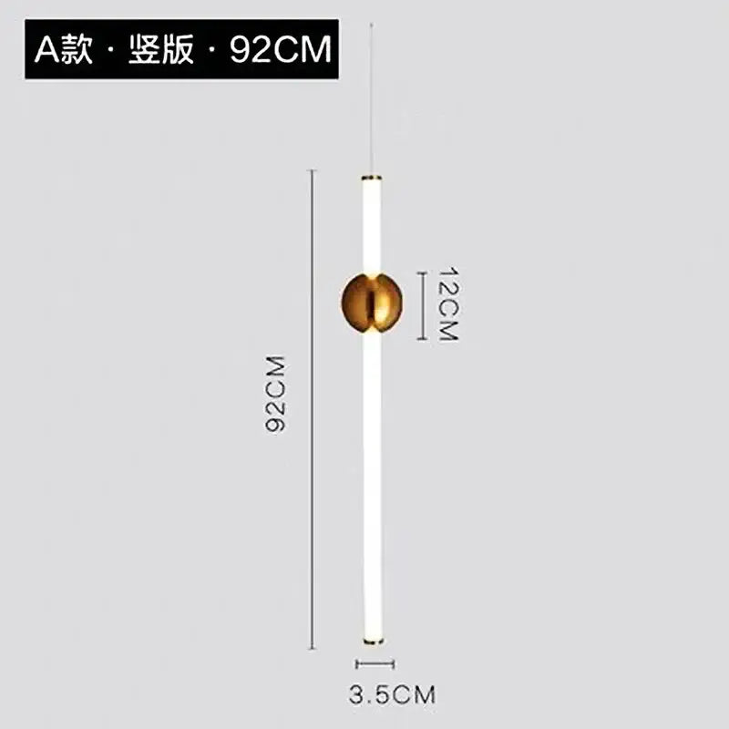 A sleek modern pendant light with a long white cylindrical body and polished gold geometric line frame accent