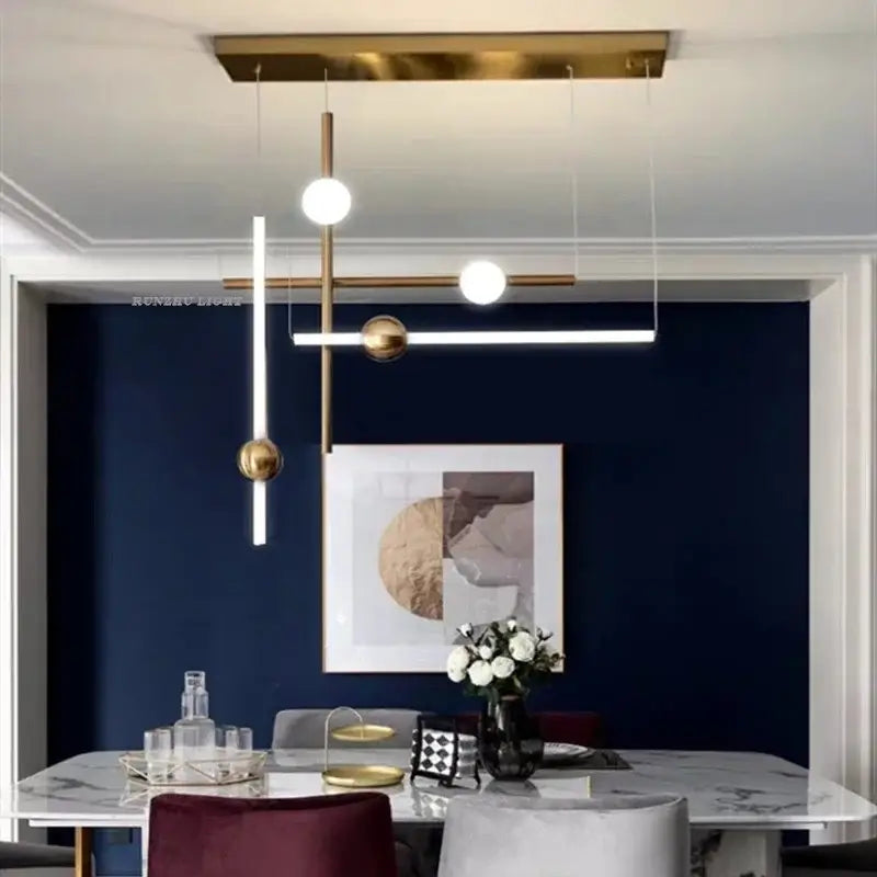 Modern gold geometric line frame pendant lights with metal arms and glass globe accents for dining room use