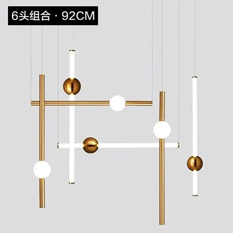 Modern gold geometric line frame pendant lights featuring gold-toned metal rods and white glass globe bulbs for dining room