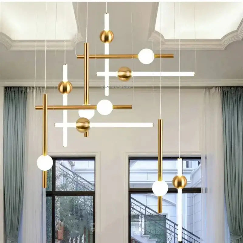 Modern gold geometric line frame pendant lights with white cylindrical rods and frosted glass globe for dining room