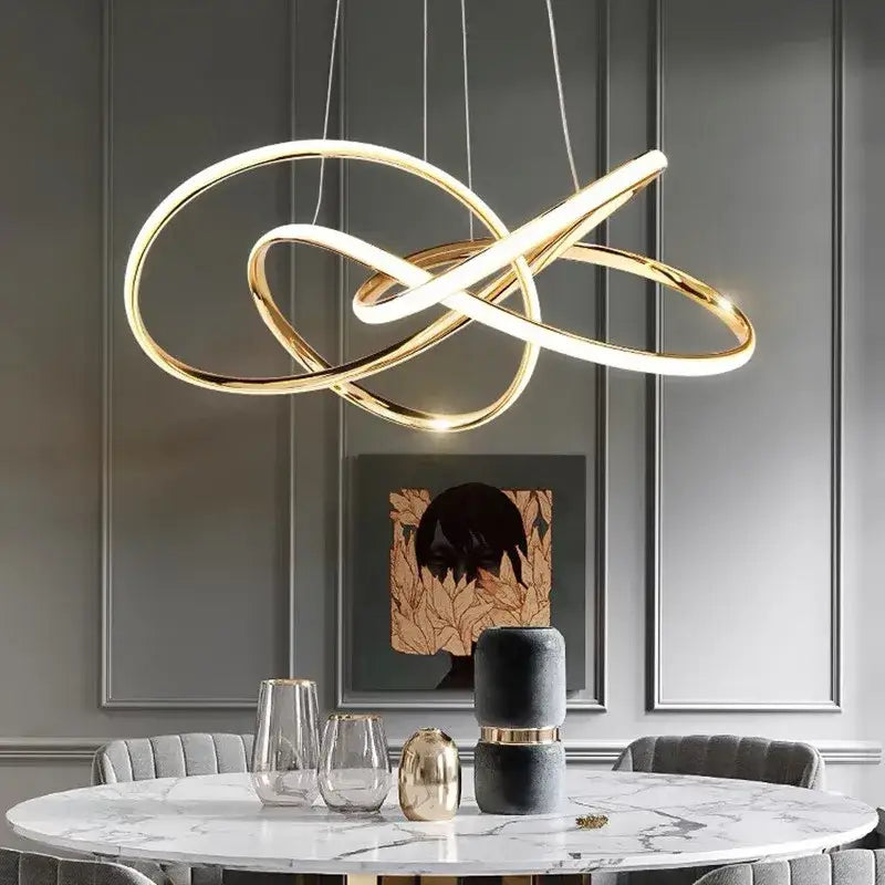 Modern gold geometric line led chandelier with intertwined circular rings and sleek minimalist design for dining room decorbites geometric line