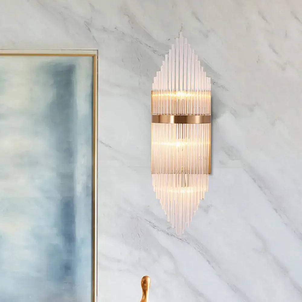 Modern gold geometric wall sconce with clear glass vertical rods and metal accents featuring fixture height detail