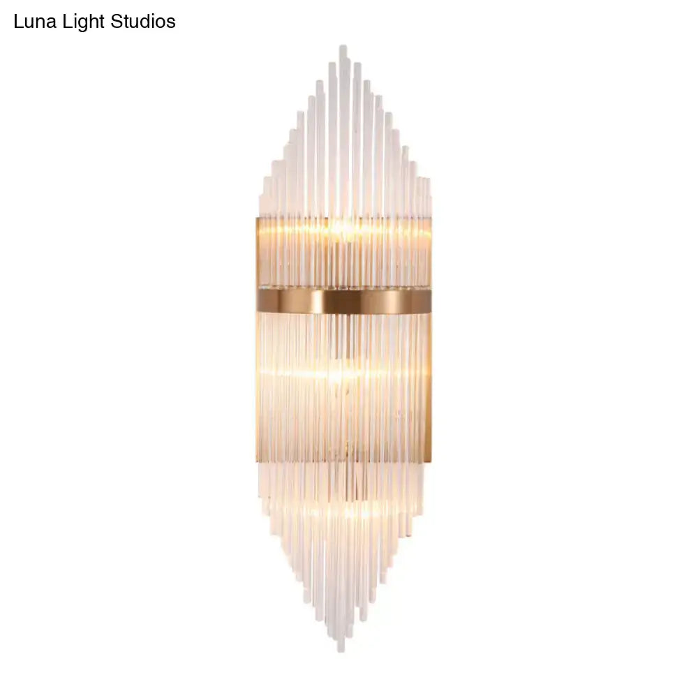 Modern gold geometric wall sconce with clear glass rods in a cascading pattern and warm brass accents for living room fixture height