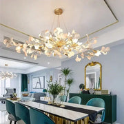 Modern gold ginkgo branch leaf led chandelier with sculptural white arms and warm lights for living room decorbites ginkgo branch