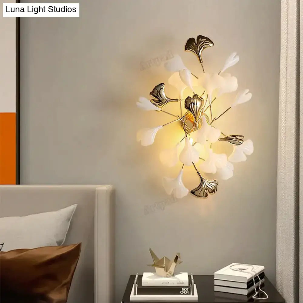 Elegant white and gold ginkgo leaf porcelain wall sconce with modern artistic design for bedroom lighting