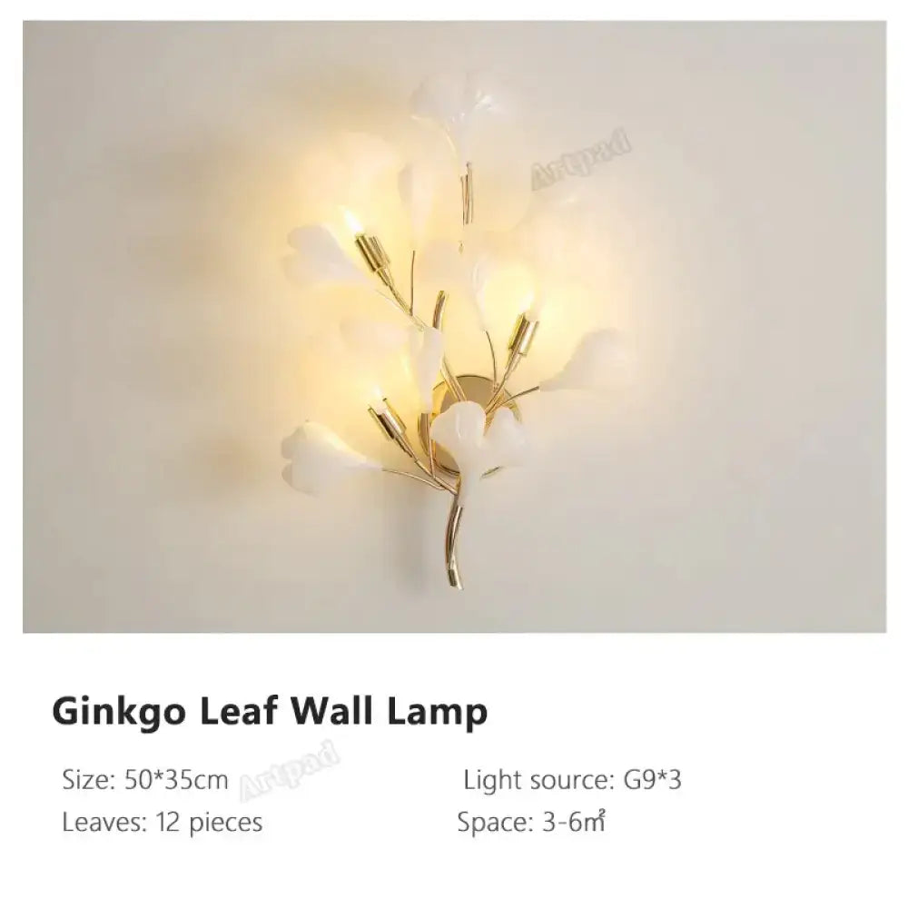 Modern gold ginkgo leaf porcelain wall sconce with translucent white petal shades in a branching design for bedroom lighting