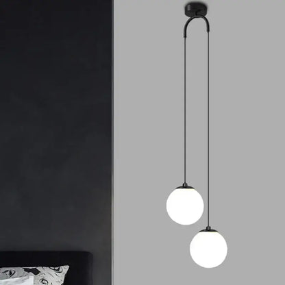 Black metal pendant light with two frosted glass ball dual globes on curved arm modern decorbites glass ball design