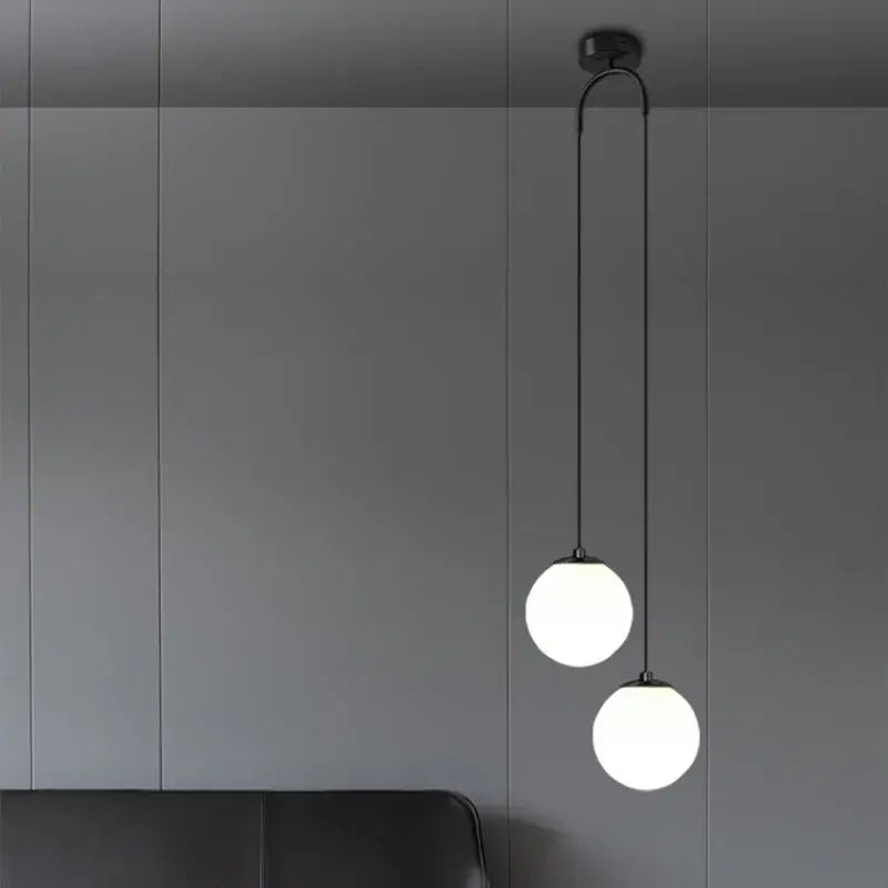 Modern gold glass ball dual head pendant light with two frosted glass globes and black cords for bedroom decorbites glass ball