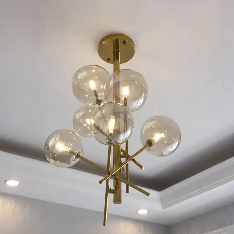 Modern gold glass ball iron chandelier with clear glass globe bulbs in a branching design for living room decorbites glass ball